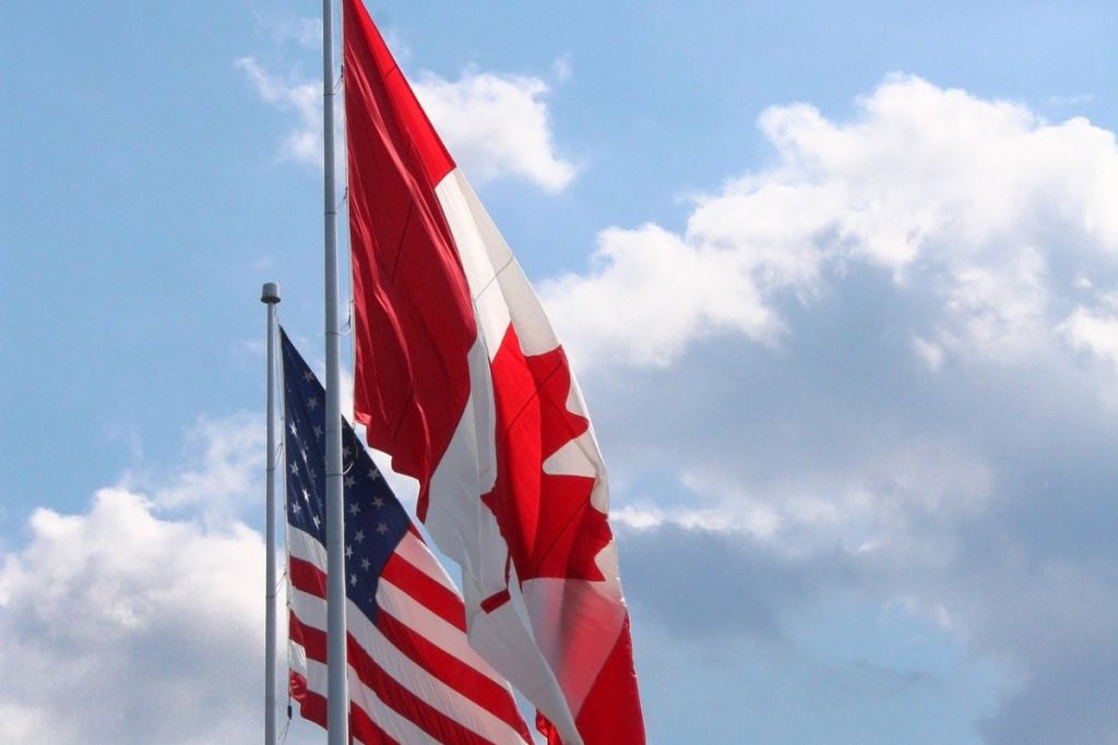 The flags of Canada and the USA beside each other